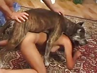 Bent over housewife satisfying her excited partner by allowing their dog to fuck her bareback