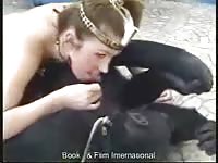 Lovely brown-haired woman is giving head to a monkey