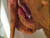 Man covers his cock in shit