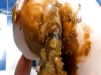 Filthy older trollop loves the way fresh streamy poop feels as she masturbates with scat here